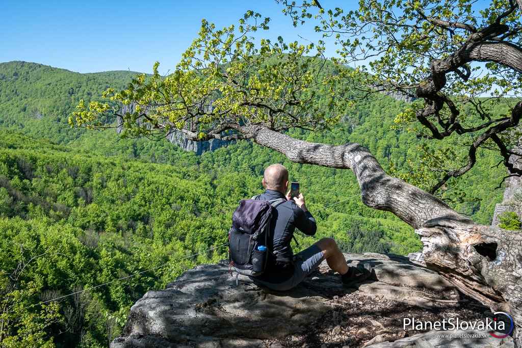 Nádherná príroda a pokoj Bystričianskej doliny na fotografii sú hlavnými bonusmi Hrádku. Všimnúť si možno i lano, po ktorom sa zvyknú spúšťať odvážlivci.